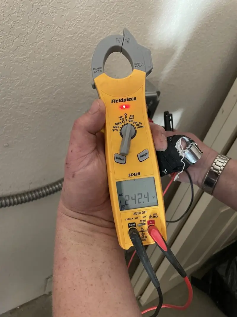 Voltage testing with clamp meter during Recessed Lighting Installation in Rumson